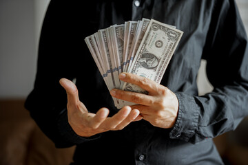 bundles of money dollars in the hands of a businessman
