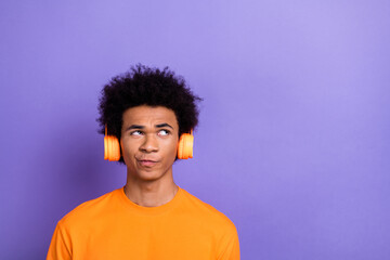 Fototapeta na wymiar Portrait photo of hipster thoughtful guy hmm listen earphones bluetooth device look mockup audio book isolated on purple color background