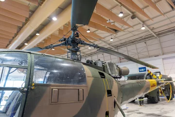 Stickers pour porte Ancien avion Military helicopter stand inside big pavilion