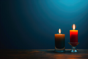 Burning candles in glass on a dark blue background with copy space text. High quality photo
