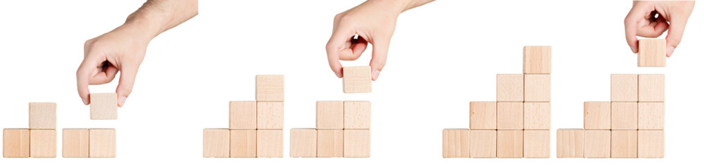 wooden cubes in the form of a pyramid with a hand on a white background, isolated background close up