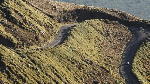 A car going up on a curvy road in the mountains of Merlo, San Luis, Argentina.