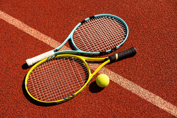 Tennis scene with balls, racquets and hard court surface corner lines