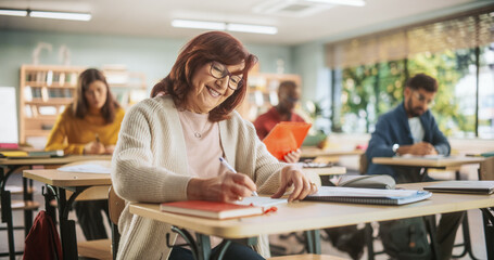 Portrait of Happy Senior Woman Taking a Course in an International Adult Education Center. Focused...