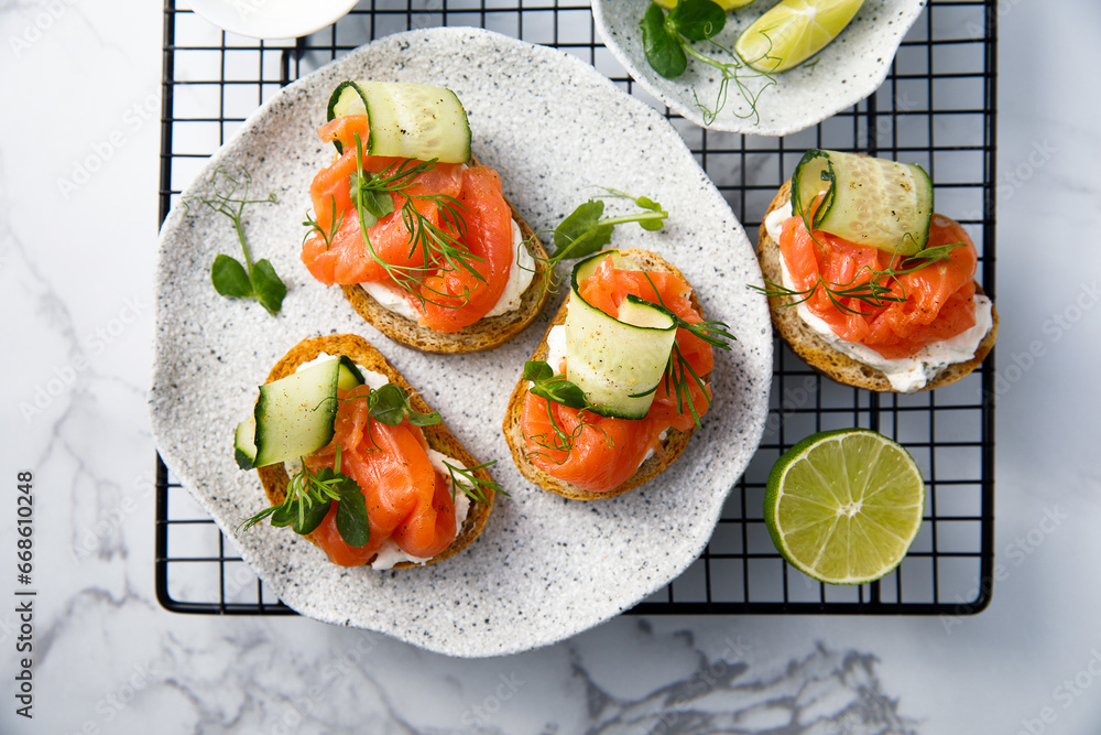 Poster Homemade crostini with smoked salmon and cucumber