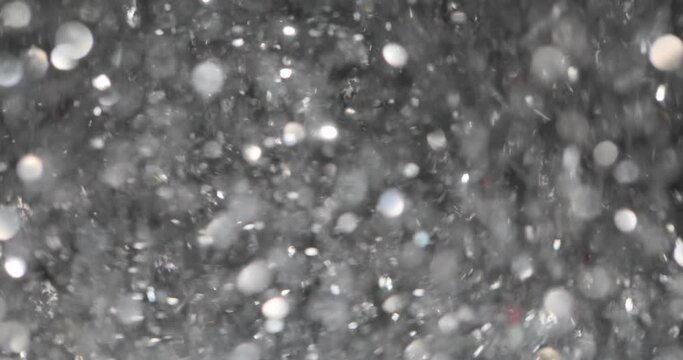 Silver glitter particles abstract background. Futuristic sparkling sequins movement