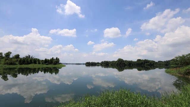 Mirror of the sky over the lake. White cloud, picturesque  landscape view.and beautiful forest prairie form a scenic scene .High quality video photography in  Renyitan Reservoir, Chiayi  City,Taiwan.