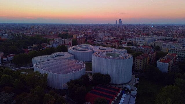 Aerial view of solar panels on the roof. The new campus of the SDA Bocconi School of Management is a modern building with classrooms. Colorful sky at sunset. Ecological energy. Milan Italy 10.2023