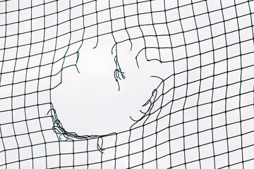 Soccer ball breaking net. Concept of football goal. Close Up of a Soccer Goal Net.