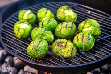 Fototapeten brussels sprouts in a bbq grill basket over hot coals © altitudevisual