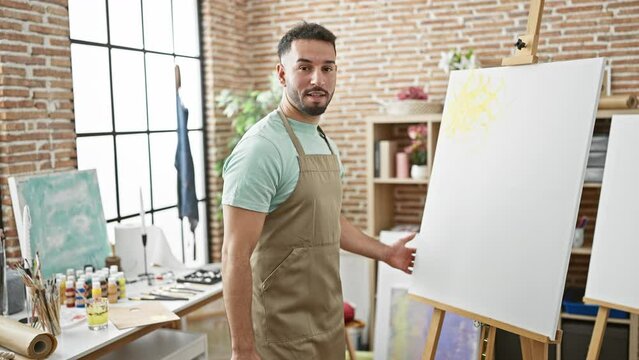 Young arab man artist having video call showing draw at art studio