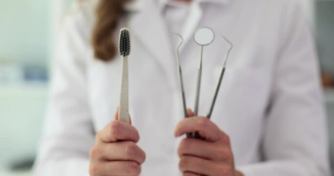 Dental kit for teeth care and toothbrush in hands of dentist. Dental services