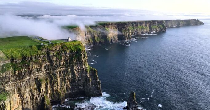 Cliffs of Moher shrouded in low clouds on a sunset 4k