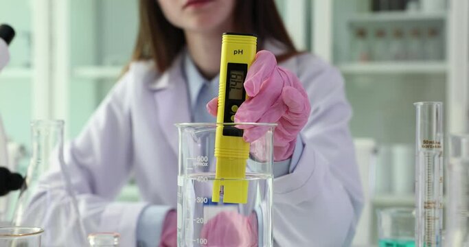 Digital water test and water analysis technology. Digital pH meter and tester for analysis in hands of scientist laboratory assistant