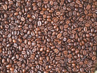 Roasted coffee beans forming a background pattern