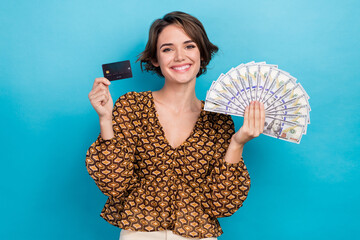 Photo of charming nice young businesswoman holding shopping premium ecard banknotes promoting...