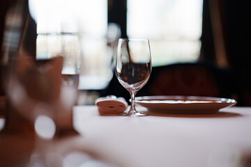An empty wine glass on a table served for a banquet. 