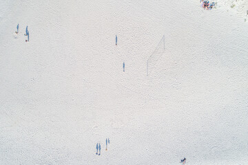 aerial zenithal view from drone of people playing beach volleyball