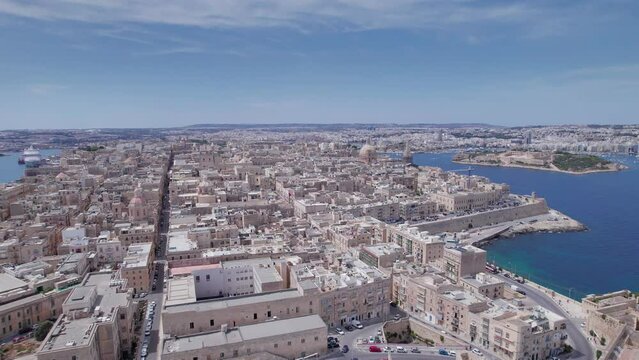 Aerial panoramic drone footage of Valletta, UNESCO World Heritage Site, Fort St Elmo, St. Paul's Cathedral, Grand Harbor Waterfront, Valletta, Malta