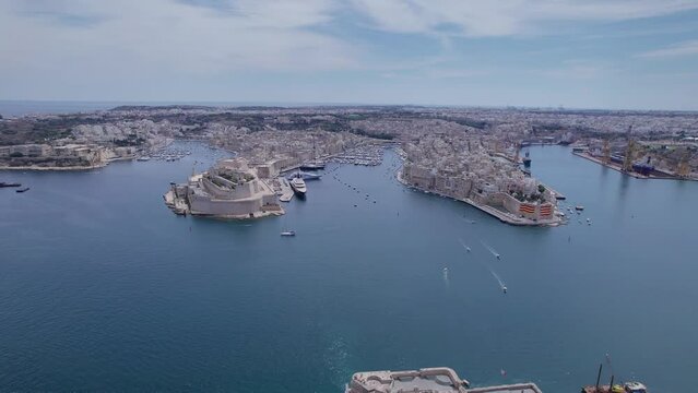 Aerial panoramic drone footage of Valletta, UNESCO World Heritage Site, Fort St Elmo, St. Paul's Cathedral, Grand Harbor Waterfront, Valletta, Malta