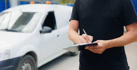 Delivery man checking products with checklist on background van car, banner logistics service