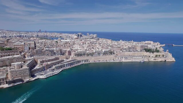 Aerial panoramic drone footage of Valletta, UNESCO World Heritage Site, Fort St Elmo, St. Paul's Cathedral, Grand Harbor Waterfront, Valletta, Malta