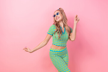 Portrait of cheerful pretty girl with tails hairdo dressed colorful suit in blue sunglass dance have fun isolated on pink color background