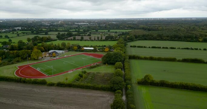 drone 4k 60fps footage of an empty soccer field at a village