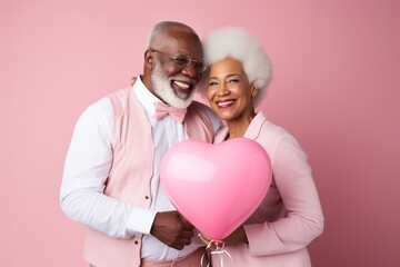 Fototapeta na wymiar Senior afro couple holding heart balloon. AI Generated.