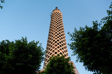 The Cairo tower in Egypt between the trees in the sky