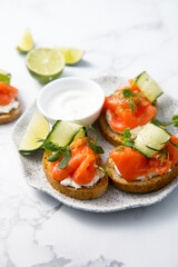 Homemade crostini with smoked salmon and cucumber