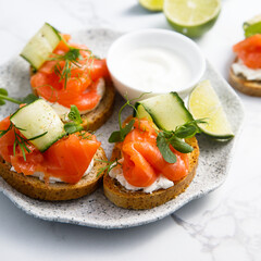 Homemade crostini with smoked salmon and cucumber