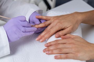 Obraz na płótnie Canvas Soothing manicure session with meticulous cuticle pushing and expert nail care at beauty salon