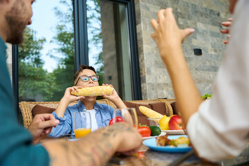 Young family is having lunch on terrace of country house