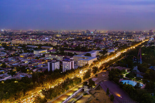 Uzbekistan, Tashkent - September 29, 2023: Top view from the observation deck on the Tashkent TV tower to the central part of the city covered with smog at nighttime . Air polution.