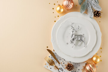 Obraz na płótnie Canvas The art of elegance: preparing your Christmas table. Top view flat lay of crockery, frosty fir branches, silver deer, cones, holiday baubles, stars on beige background with advert spot