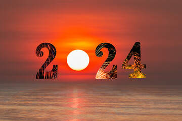 Happy New Year 2024  concept image with text  over sea on sun rising sky background