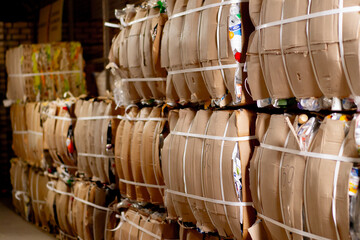 Close-up shot of a corridor with paper boxes filled with old things for recycling at recycling center
