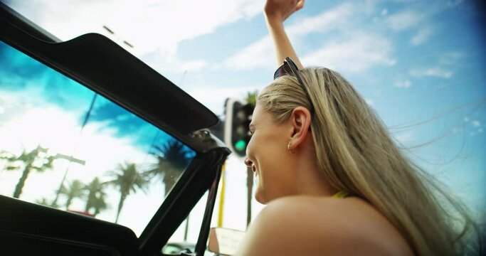 Happy, woman and driving with freedom and travel with road trip in Miami in summer with smile. Blue sky, holiday and transport adventure with a car, person and transportation with a journey outdoor
