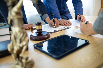 Businessmen and investors sign contract in front of company legal advisor and witness contract for their real estate investment. signing contract between businessman and an investor in front of lawyer