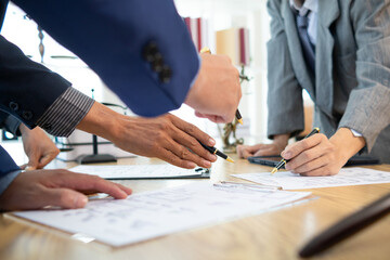 Businessmen and investors sign contract in front of company legal advisor and witness contract for their real estate investment. signing contract between businessman and an investor in front of lawyer - obrazy, fototapety, plakaty