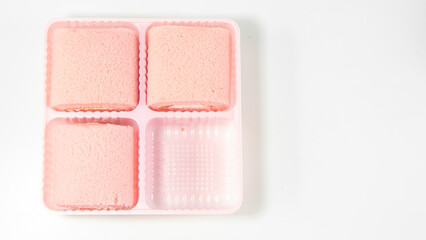Strawberry roll cake on white background. Rose strawberry cake placed on a plate
