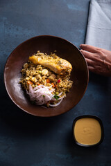 Traditional Peruvian dish seen from above on a blue background.