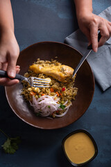 Traditional Peruvian dish seen from above on a blue background.