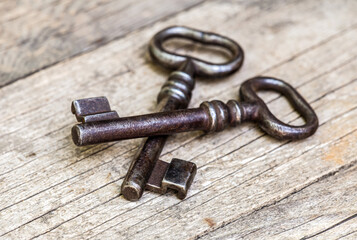 Old iron keys on wooden background. Top secret, confidential or classified concept.