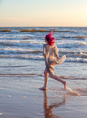 Young woman enjoys nature walking along the seashore