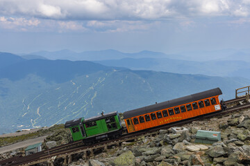 Cogwheel train completing the last and steep stretch on the track to the top of Mt Washington, New Hampshire, USA