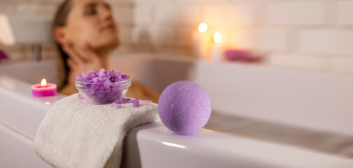 woman enjoying bathtub with sea salt crystals and bath bomb. home spa. banner with copy space