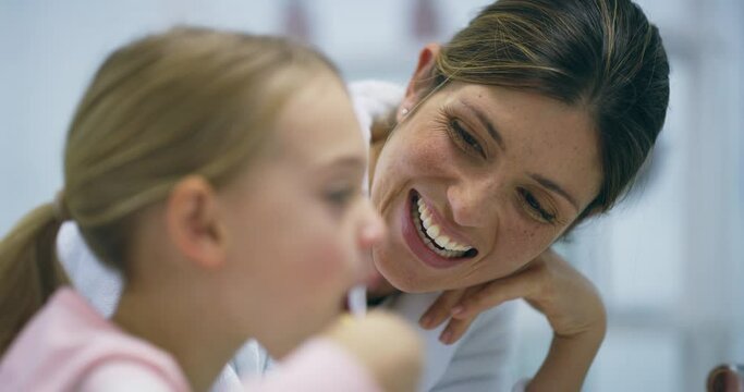 Bathroom, girl and mother with a smile, brushing teeth or child development with teaching, oral health or wellness. Family, home or mama with kid, whitening or toothbrush with dental hygiene or happy