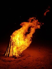 A bonfire burns at night